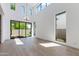 Sunlit living space with high ceilings, large windows, and a modern chandelier and backyard access at 100 W Northern Ave # 12, Phoenix, AZ 85021