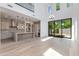 Bright, open-concept living area featuring a modern kitchen, sleek light fixtures, and backyard access at 100 W Northern Ave # 12, Phoenix, AZ 85021