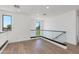 Upstairs loft featuring hard wood floors, white walls, and black-framed windows at 100 W Northern Ave # 12, Phoenix, AZ 85021