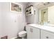 Bathroom with granite countertops, white cabinets, and framed mirror at 10161 W Thunderbird Blvd, Sun City, AZ 85351