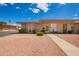 Charming single-story home featuring a well-maintained yard and inviting walkway, creating a warm and welcoming entrance at 10161 W Thunderbird Blvd, Sun City, AZ 85351