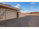 Tan painted garage with gate, solar panels, and neighborhood palm trees at 10161 W Thunderbird Blvd, Sun City, AZ 85351