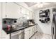 Well-appointed kitchen with stainless steel appliances, sleek countertops, and ample storage space for culinary enthusiasts at 10161 W Thunderbird Blvd, Sun City, AZ 85351