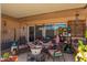 Cozy covered patio with outdoor seating, decor, and memorabilia for the Gathering at 10161 W Thunderbird Blvd, Sun City, AZ 85351