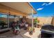 Relax on this covered patio with seating, decor, and easy access to the home at 10161 W Thunderbird Blvd, Sun City, AZ 85351