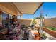 Covered patio with outdoor seating, desert plants, and easy access to the home at 10161 W Thunderbird Blvd, Sun City, AZ 85351