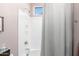 Bright bathroom featuring a shower-tub combination with white tile and soft pink walls at 10206 E Texas Ave, Mesa, AZ 85212