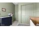 This Bedroom boasts sage green walls with charming paneled trim and a gray area rug at 10206 E Texas Ave, Mesa, AZ 85212