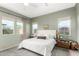 Serene bedroom with three windows, neutral tones, plush bedding, and ample natural light at 10206 E Texas Ave, Mesa, AZ 85212