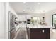 Well-lit kitchen with white cabinets, a large island, stainless steel appliances, and open layout at 10206 E Texas Ave, Mesa, AZ 85212