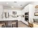 Bright kitchen with white cabinets, stainless steel appliances, large island, and a cozy breakfast nook at 10206 E Texas Ave, Mesa, AZ 85212