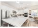 Bright, modern kitchen featuring a large island with seating, white cabinets, and stainless appliances at 10206 E Texas Ave, Mesa, AZ 85212