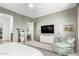 Spacious bedroom featuring a TV, large windows, sitting area, and soothing color palette at 10206 E Texas Ave, Mesa, AZ 85212
