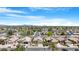 An aerial view captures a neighborhood with well-maintained homes, landscaping, and clear blue skies at 1049 N Monterey St, Gilbert, AZ 85233