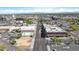 Straight shot aerial view of a city street, showcasing storefronts, buildings, and cars under a clear blue sky at 1049 N Monterey St, Gilbert, AZ 85233