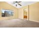 Large bedroom with neutral carpeting, an ensuite bathroom, and ample natural light at 1049 N Monterey St, Gilbert, AZ 85233