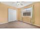 Bedroom features a window, closet with white doors, carpet and a ceiling fan at 1049 N Monterey St, Gilbert, AZ 85233
