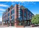 Modern three-story building with a brick and gray facade, featuring large windows and unique architectural details at 1049 N Monterey St, Gilbert, AZ 85233
