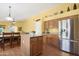 Bright kitchen with stainless steel appliances, a central island, and a connected dining area at 1049 N Monterey St, Gilbert, AZ 85233
