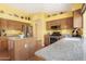 Bright kitchen featuring updated appliances, granite counters, and hardwood floors at 1049 N Monterey St, Gilbert, AZ 85233