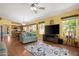 Open-concept living room with seamless flow to kitchen and dining area, with hardwood floors at 1049 N Monterey St, Gilbert, AZ 85233