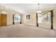 Spacious living room with neutral carpet, high ceilings, and views of the front yard at 1049 N Monterey St, Gilbert, AZ 85233