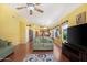 Spacious living room featuring hardwood floors, a ceiling fan, and great natural light at 1049 N Monterey St, Gilbert, AZ 85233