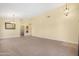 Expansive living room with neutral carpet, high ceilings, and open access to other rooms at 1049 N Monterey St, Gilbert, AZ 85233