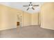 Spacious main bedroom features a ceiling fan, neutral carpet, and an ensuite bathroom at 1049 N Monterey St, Gilbert, AZ 85233