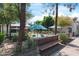 Outdoor seating area with patio umbrellas and benches, set amongst lush greenery and trees in a peaceful setting at 1049 N Monterey St, Gilbert, AZ 85233