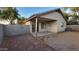 Rear exterior showcasing a covered patio, low maintenance landscaping and block fencing at 10645 W Piccadilly Rd, Avondale, AZ 85392