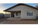 Rear exterior showcasing a covered patio, low maintenance landscaping and an AC unit at 10645 W Piccadilly Rd, Avondale, AZ 85392