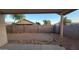 Backyard with partial view of a covered patio, block fence and low maintenance landscaping at 10645 W Piccadilly Rd, Avondale, AZ 85392