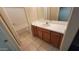 Bathroom features a shower and tub combination, wood cabinets and a single sink vanity at 10645 W Piccadilly Rd, Avondale, AZ 85392