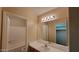 Bright bathroom features a shower and tub combination, with a single sink vanity and a large mirror at 10645 W Piccadilly Rd, Avondale, AZ 85392