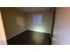 Inviting bedroom featuring wood floors, neutral walls, and a window providing ample natural light at 10645 W Piccadilly Rd, Avondale, AZ 85392