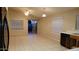 Open dining area featuring tiled floors, modern light fixtures, and sliding glass doors to backyard at 10645 W Piccadilly Rd, Avondale, AZ 85392