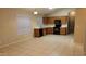 Spacious kitchen featuring tiled floors, modern appliances, ample countertop space, and wood cabinets at 10645 W Piccadilly Rd, Avondale, AZ 85392