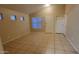 Spacious living room with tile floors, multiple windows for ample natural light and a neutral color palette at 10645 W Piccadilly Rd, Avondale, AZ 85392