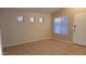 Bright, airy living room featuring neutral walls, tiled floors, and multiple windows with privacy blinds at 10645 W Piccadilly Rd, Avondale, AZ 85392