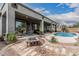 Backyard featuring a covered patio, outdoor seating, fire pit, and desert landscaping, ideal for relaxation and entertaining at 11611 N 149Th Ln, Surprise, AZ 85379
