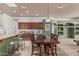 Bright eat-in kitchen with tile floors, wooden table with chairs, and stainless steel appliances at 11611 N 149Th Ln, Surprise, AZ 85379
