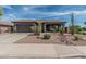 Charming single-story home featuring desert landscaping, a two-car garage, and a covered front porch at 11611 N 149Th Ln, Surprise, AZ 85379