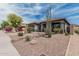 A beautiful home featuring xeriscape landscaping, a covered front porch, and desert plants under a blue sky at 11611 N 149Th Ln, Surprise, AZ 85379