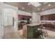 Well-lit kitchen features an island with bar seating, stainless steel appliances, and granite countertops at 11611 N 149Th Ln, Surprise, AZ 85379