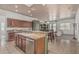 Open kitchen with granite countertops, dark cabinets, a kitchen island, and stainless steel appliances at 11611 N 149Th Ln, Surprise, AZ 85379