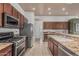 Modern kitchen featuring stainless steel appliances, granite countertops, and ample cabinet space at 11611 N 149Th Ln, Surprise, AZ 85379