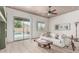 Bright living room featuring a sliding glass door to the pool area, a ceiling fan, and a comfortable couch at 11611 N 149Th Ln, Surprise, AZ 85379