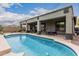 Inviting pool with a covered patio and outdoor seating, perfect for entertaining and relaxation at 11611 N 149Th Ln, Surprise, AZ 85379