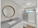 Bathroom featuring a wood-trimmed mirror, vanity, and a shower/tub combo at 11889 N 113Th Pl, Scottsdale, AZ 85259